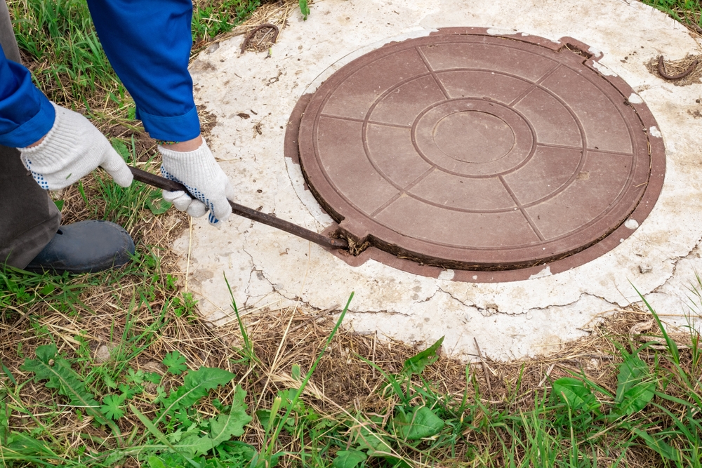 The,worker,opens,the,manhole,cover,to,inspect,and,check