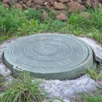 Green,plastic,manhole,cover,of,the,septic,tank